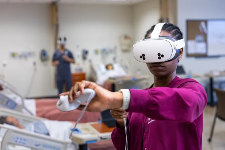 3050611 nccu student wearing maroon sweatshirt uses vrclinicals for nursing in classroom 669e1421b8.webp