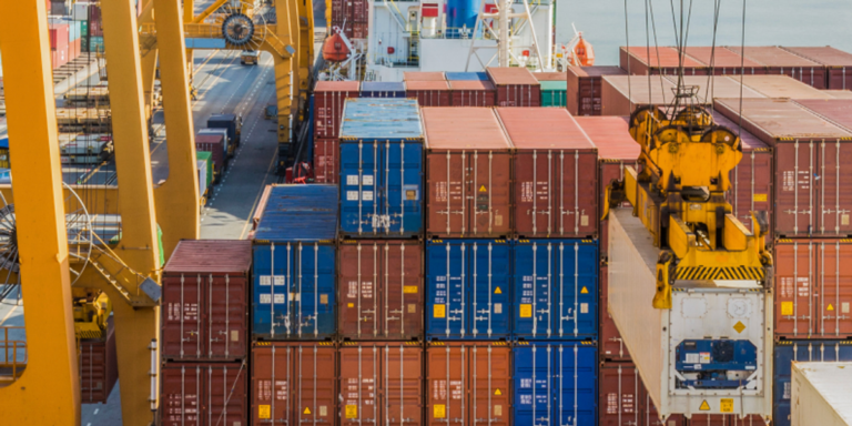Photo of containers stacked at a port.png
